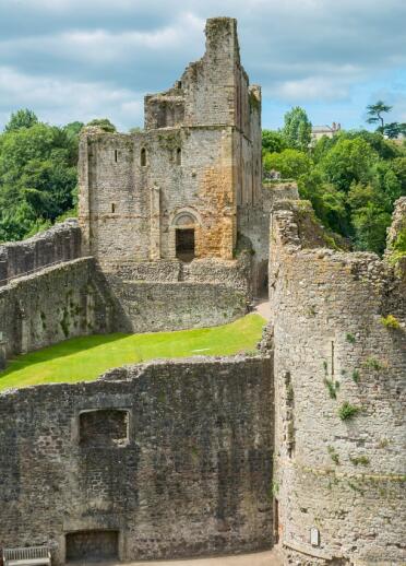 Two towers inside Chepstow Castle showing the ruins of war.