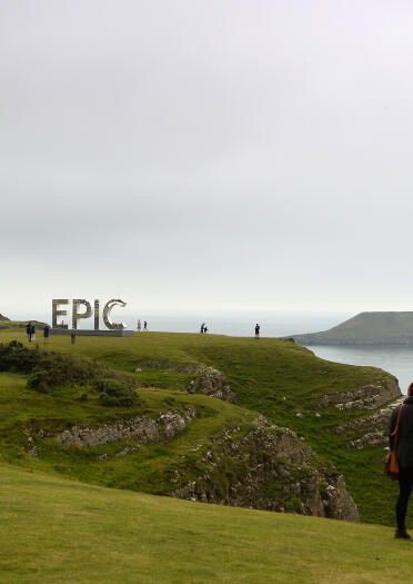 Walkers enjoying the view of Worms Head, Rhossili on the Gower.