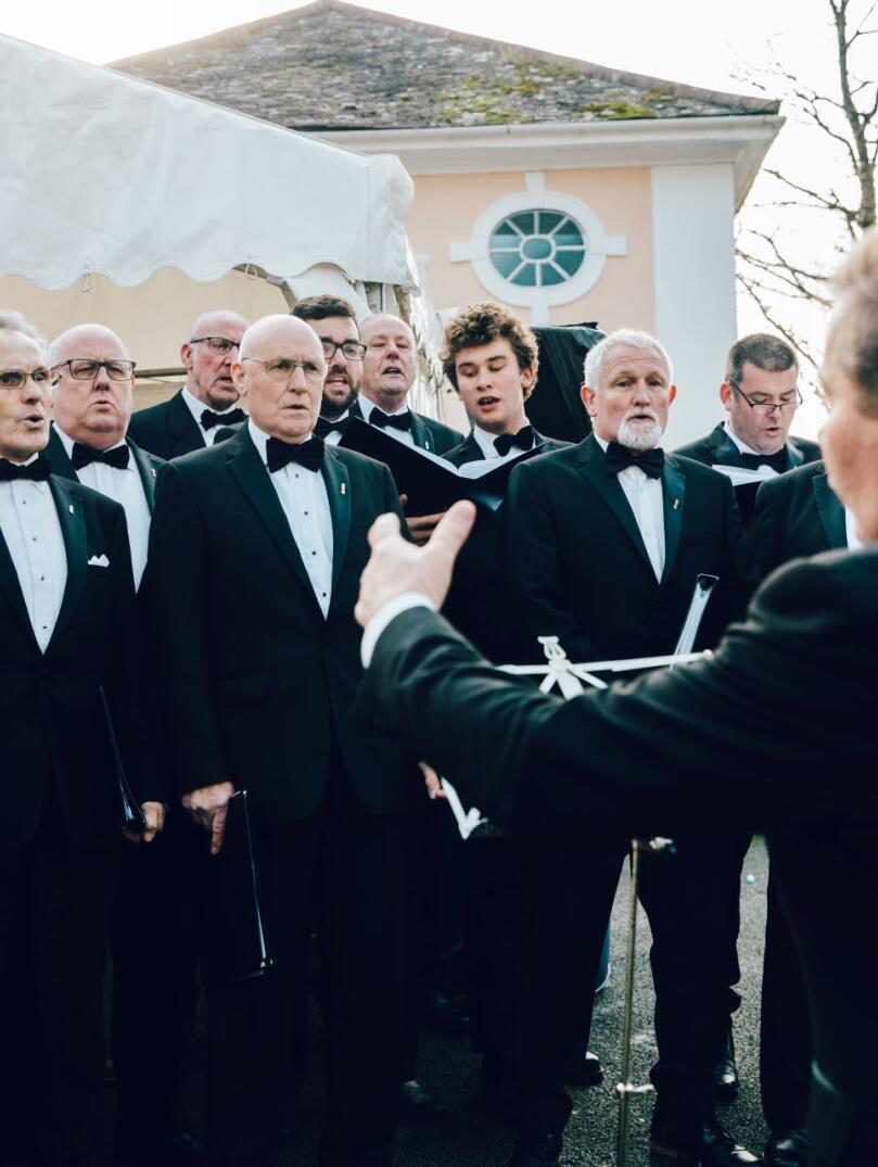 Male voice choir singing and being conducted at Portmeirion.