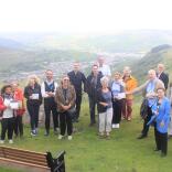 A group of people standing on a mountain on a tour of the valleys.